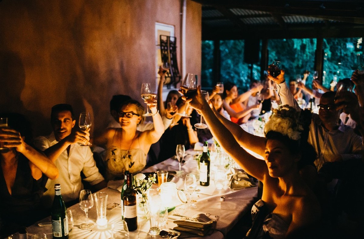 Guests speak and sing at the reception in a two-photo collage. Photograph by documentary wedding photographer Joshua Mikhaiel.