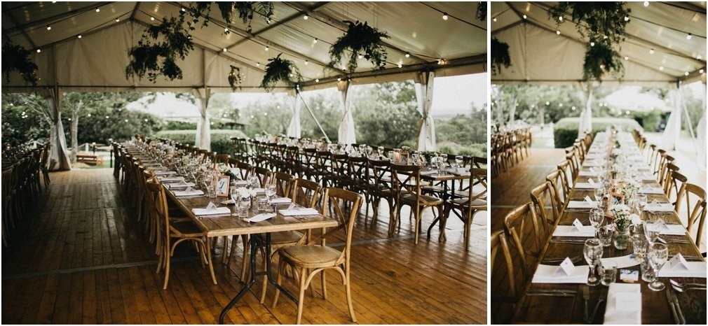 Long tables are set inside a clear marquee beside the garden, photographed by documentary wedding photographer Joshua Mikhaiel.