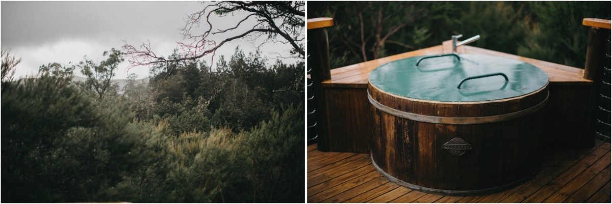 A timber cabin and outdoor hot tub sit among trees at Cradle Mountain, photographed by documentary wedding photographer Joshua Mikhaiel.