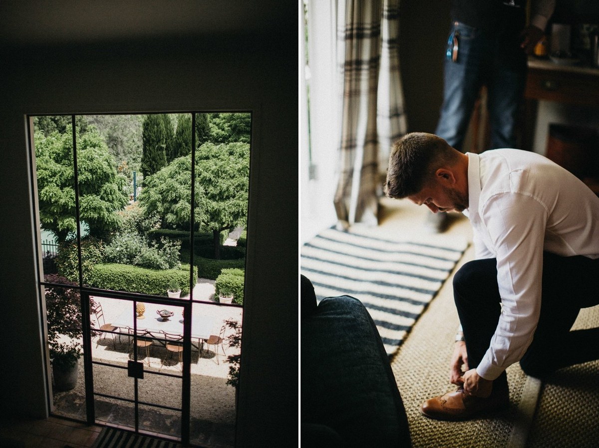 The groom bends down to adjust his shoes beside a window. Photograph by documentary wedding photographer Joshua Mikhaiel.