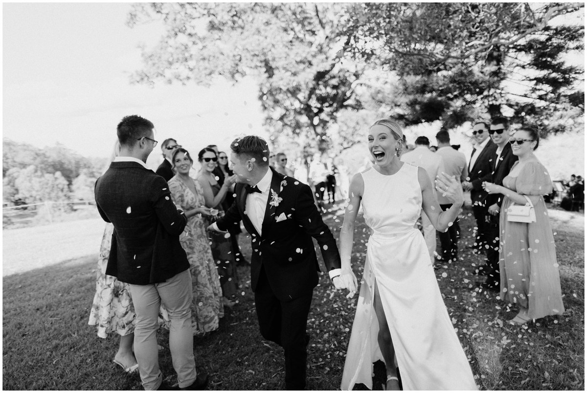 Confetti with the wedding party — Joshua Mikhaiel, documentary wedding photographer A bride and groom celebrate with their wedding party in a shower of confetti. Photograph by documentary wedding photographer Joshua Mikhaiel.