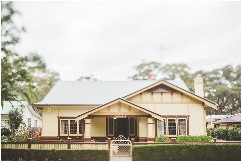 Family home and garden — Joshua Mikhaiel, documentary wedding photographer A single-storey house stands behind a front lawn and garden fence, photographed by documentary photographer Joshua Mikhaiel.