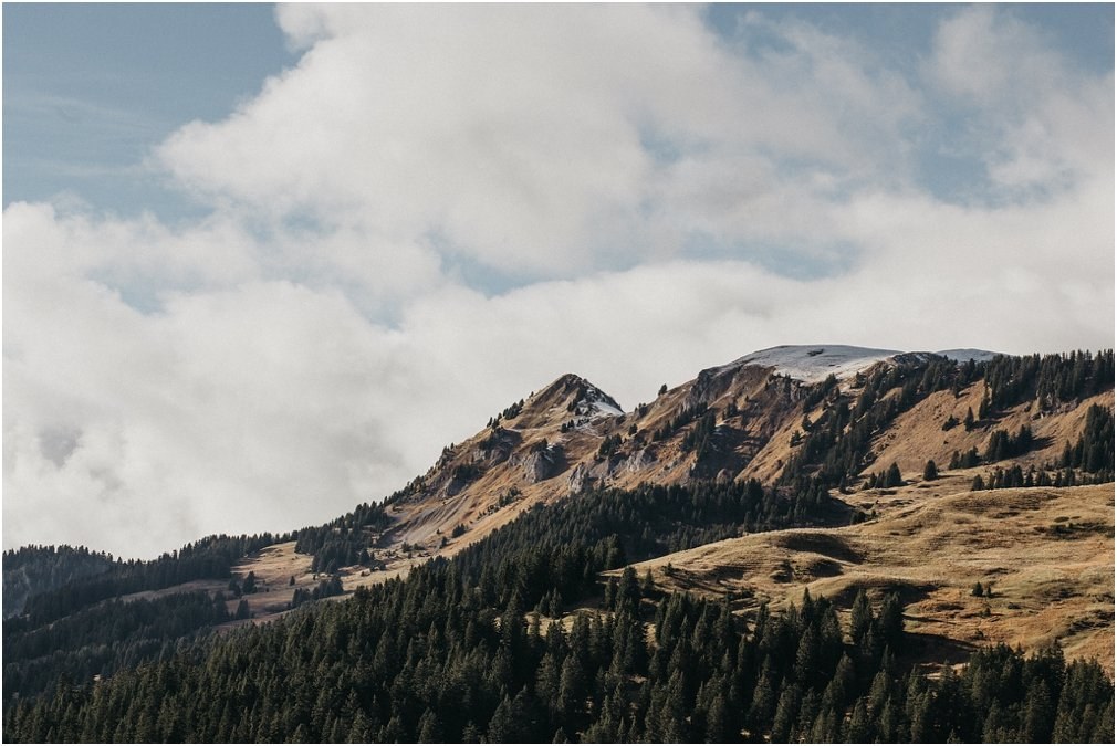 Clouds over an alpine ridge — Joshua Mikhaiel, documentary wedding photographer Clouds gather around a rugged alpine ridge above a grassy slope, photographed by documentary wedding photographer Joshua Mikhaiel.