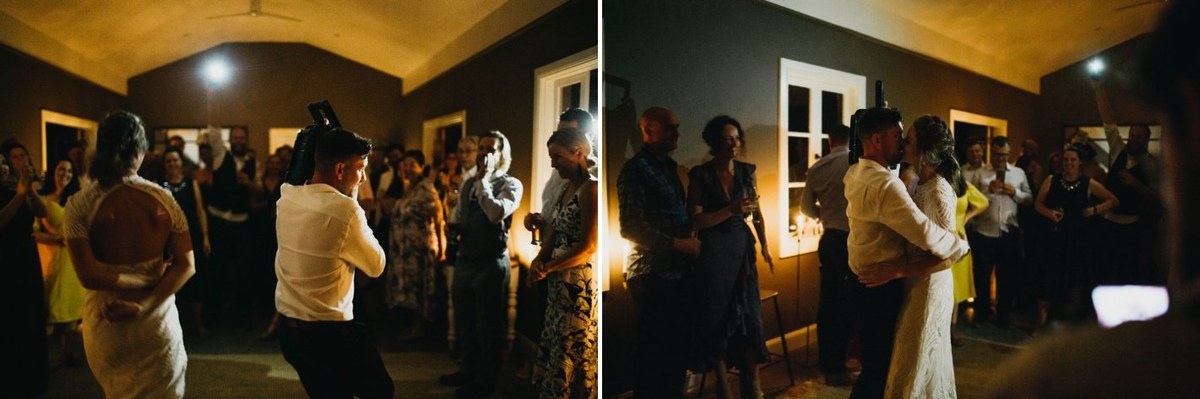 A guest dances with one arm raised in the reception room. Photograph by documentary wedding photographer Joshua Mikhaiel.