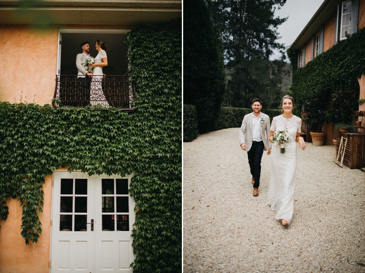 The bride and groom stand together in a doorway and walk along the garden path. Photograph by documentary wedding photographer Joshua Mikhaiel.