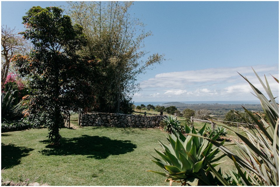A landscaped lawn and mature trees overlook the valley at Byron View Farm. Photograph by documentary wedding photographer Joshua Mikhaiel.