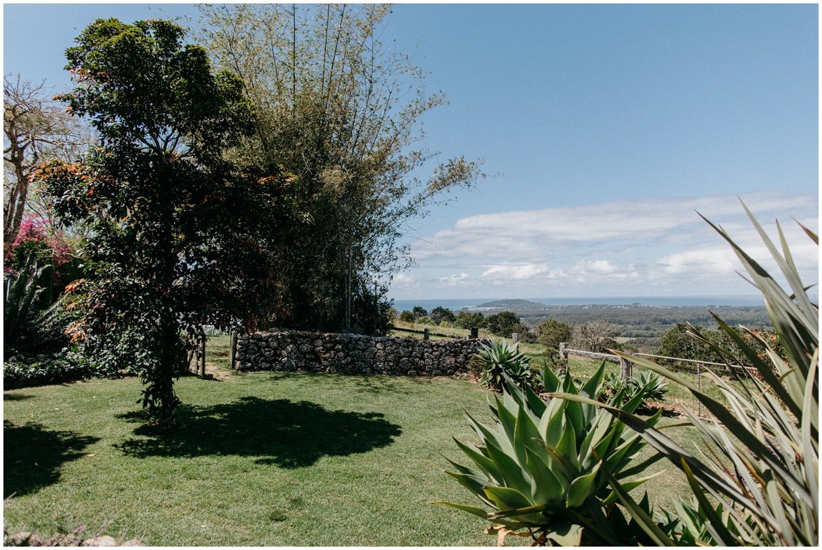 A landscaped lawn and mature trees overlook the valley at Byron View Farm. Photograph by documentary wedding photographer Joshua Mikhaiel.