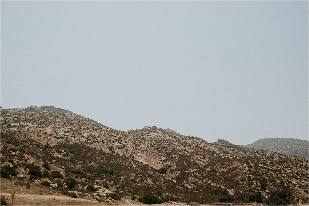Rolling hillside near the wedding venue — Joshua Mikhaiel, documentary wedding photographer A dry, rolling hillside stretches beneath a pale sky, photographed by documentary wedding photographer Joshua Mikhaiel.