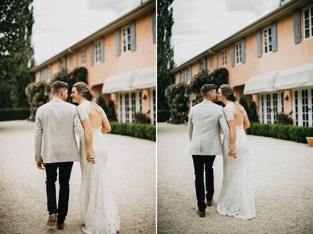 The bride and groom walk together in front of the homestead. Photograph by documentary wedding photographer Joshua Mikhaiel.