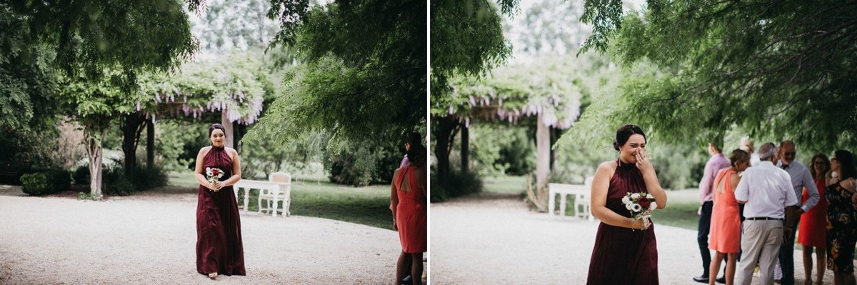 The bride and her attendants gather beside the garden path. Photograph by documentary wedding photographer Joshua Mikhaiel.