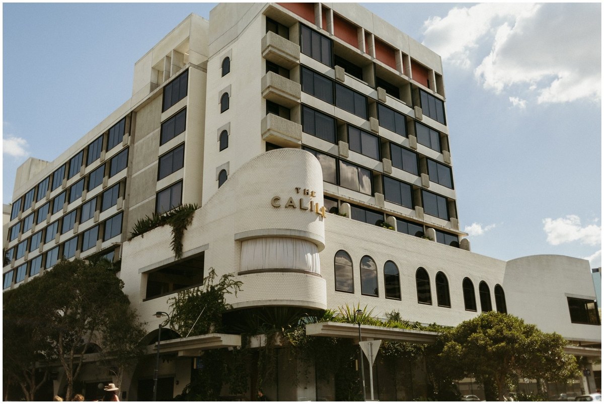 The Refinery Brisbane — Joshua Mikhaiel, documentary wedding photographer The curved facade of The Refinery rises above the street in Brisbane. Photograph by documentary wedding photographer Joshua Mikhaiel.