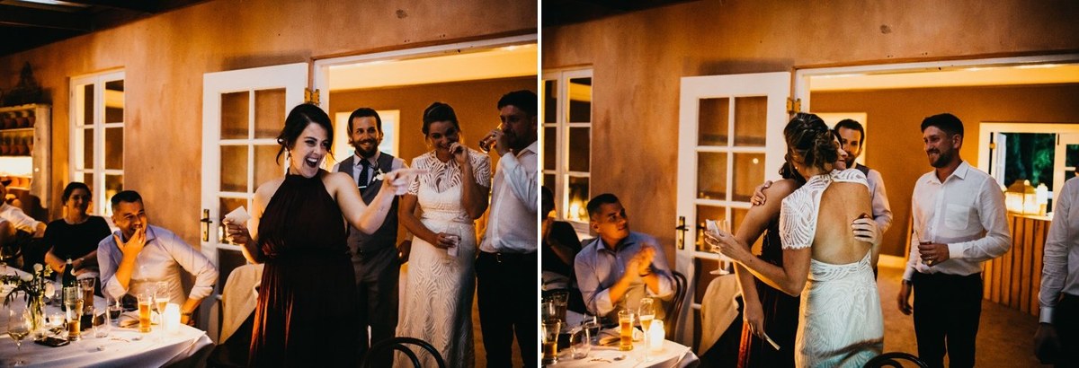 Guests raise their hands and dance around the tables. Photograph by documentary wedding photographer Joshua Mikhaiel.