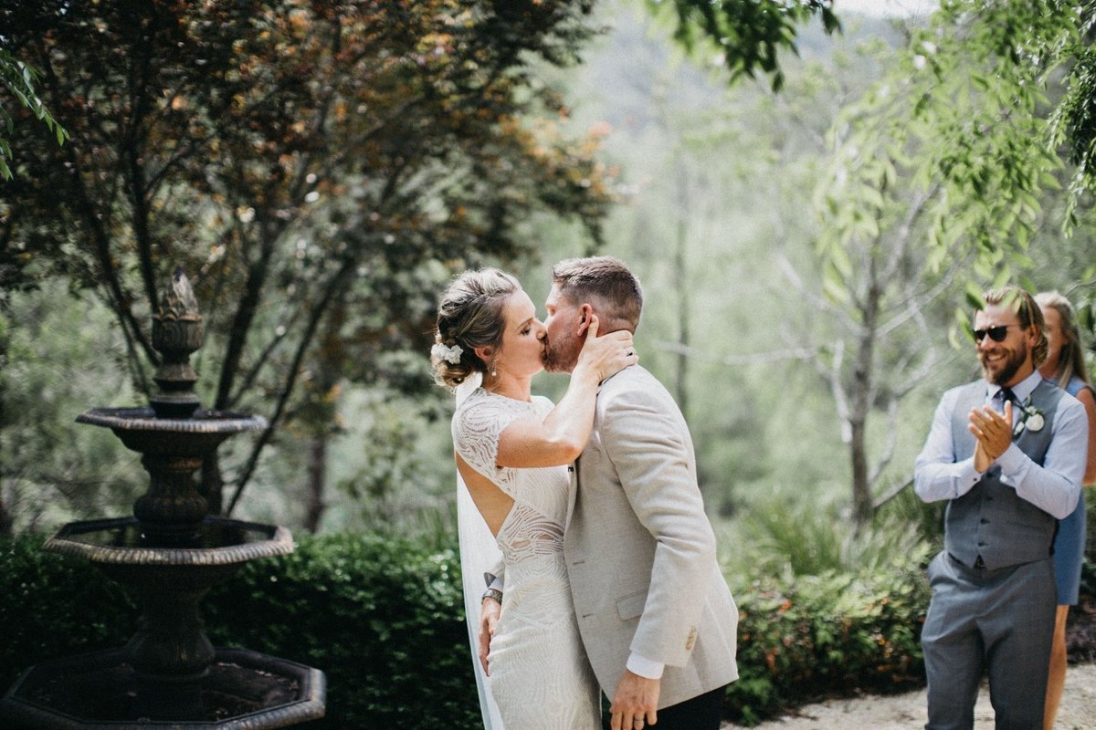 The bride and groom kiss after exchanging vows. Photograph by documentary wedding photographer Joshua Mikhaiel.
