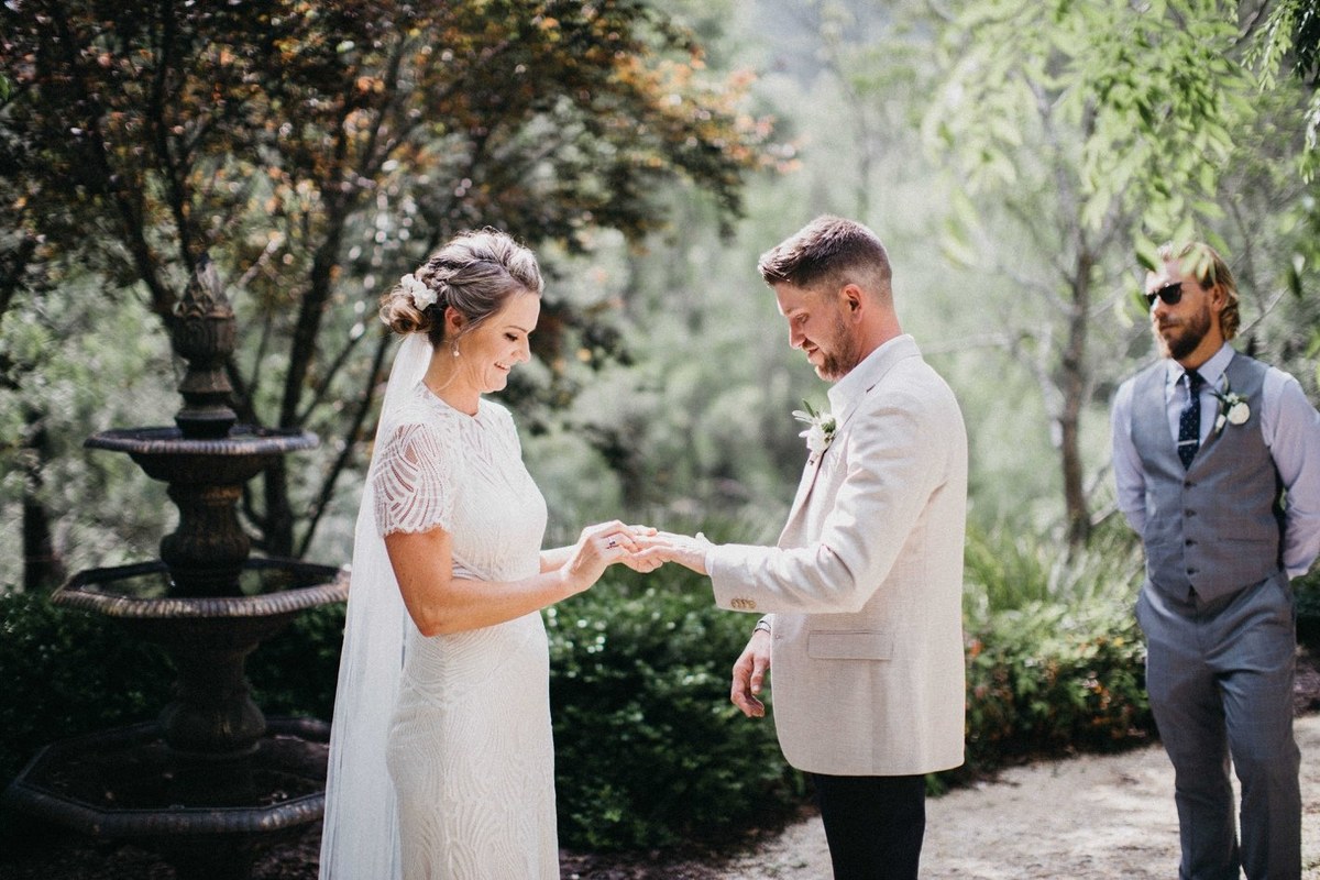 Guests watch as the couple share a moment during the ceremony. Photograph by documentary wedding photographer Joshua Mikhaiel.